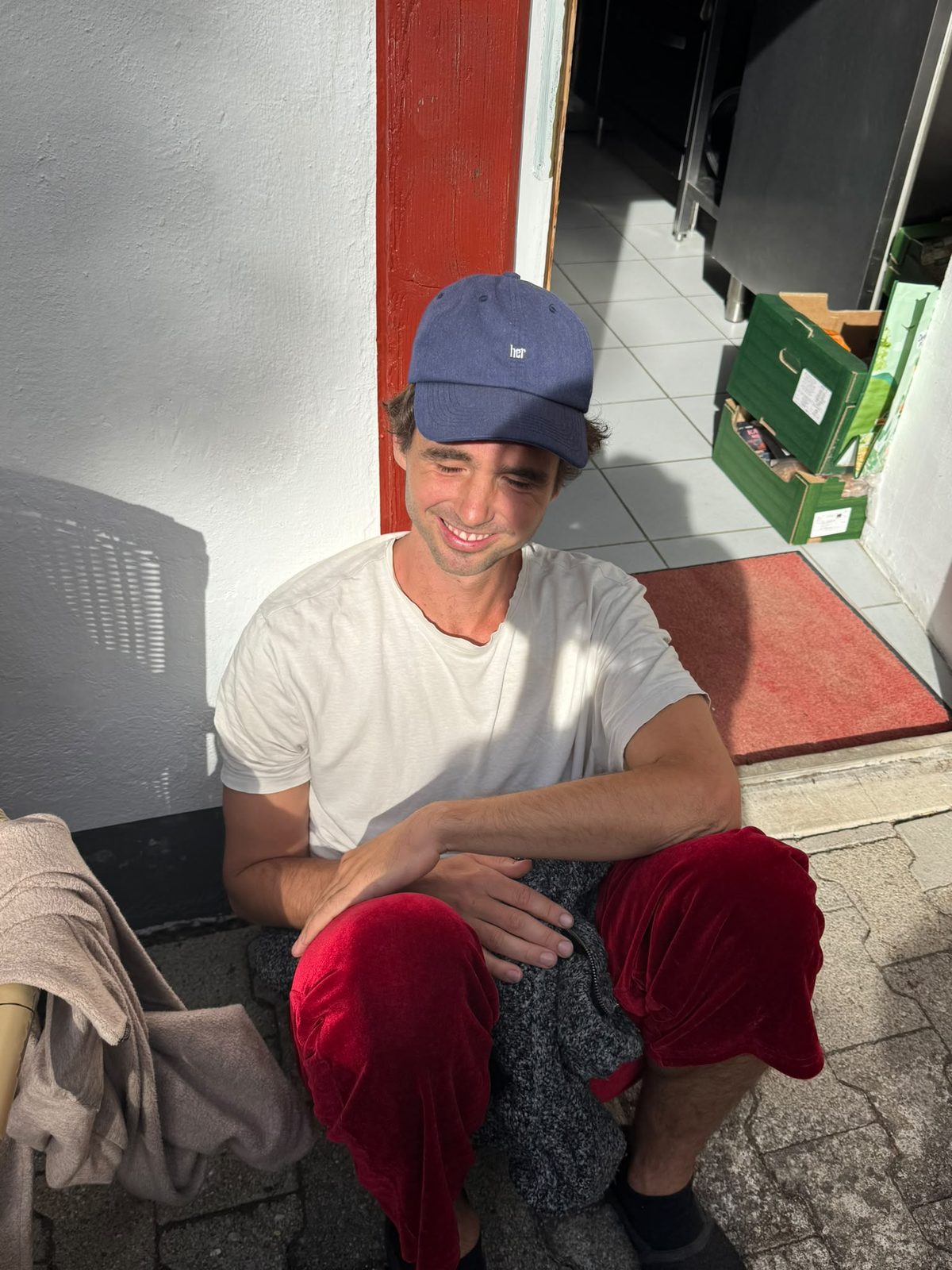 A participant smiling on the doorstep