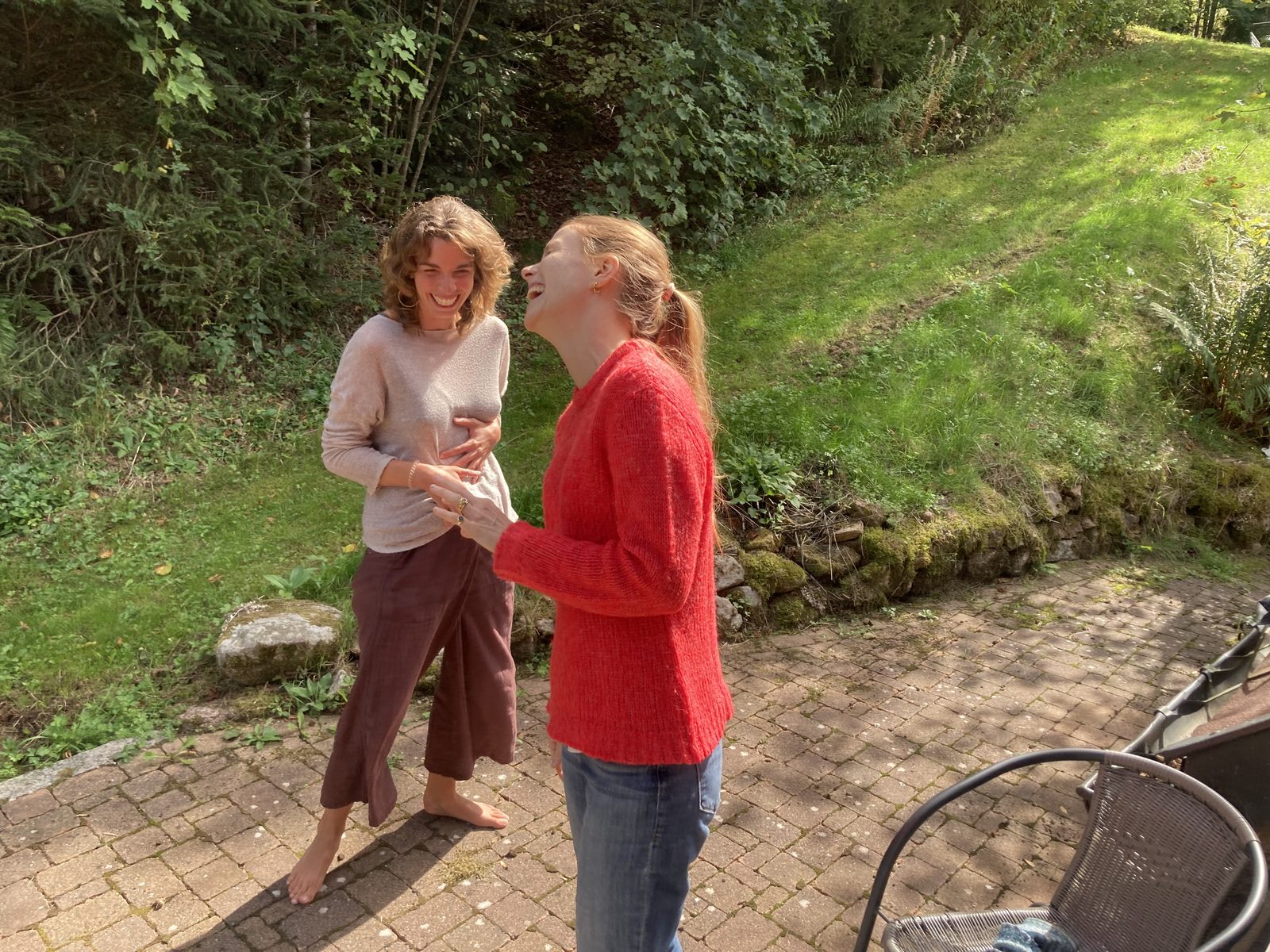 Two participants laughing together in the garden