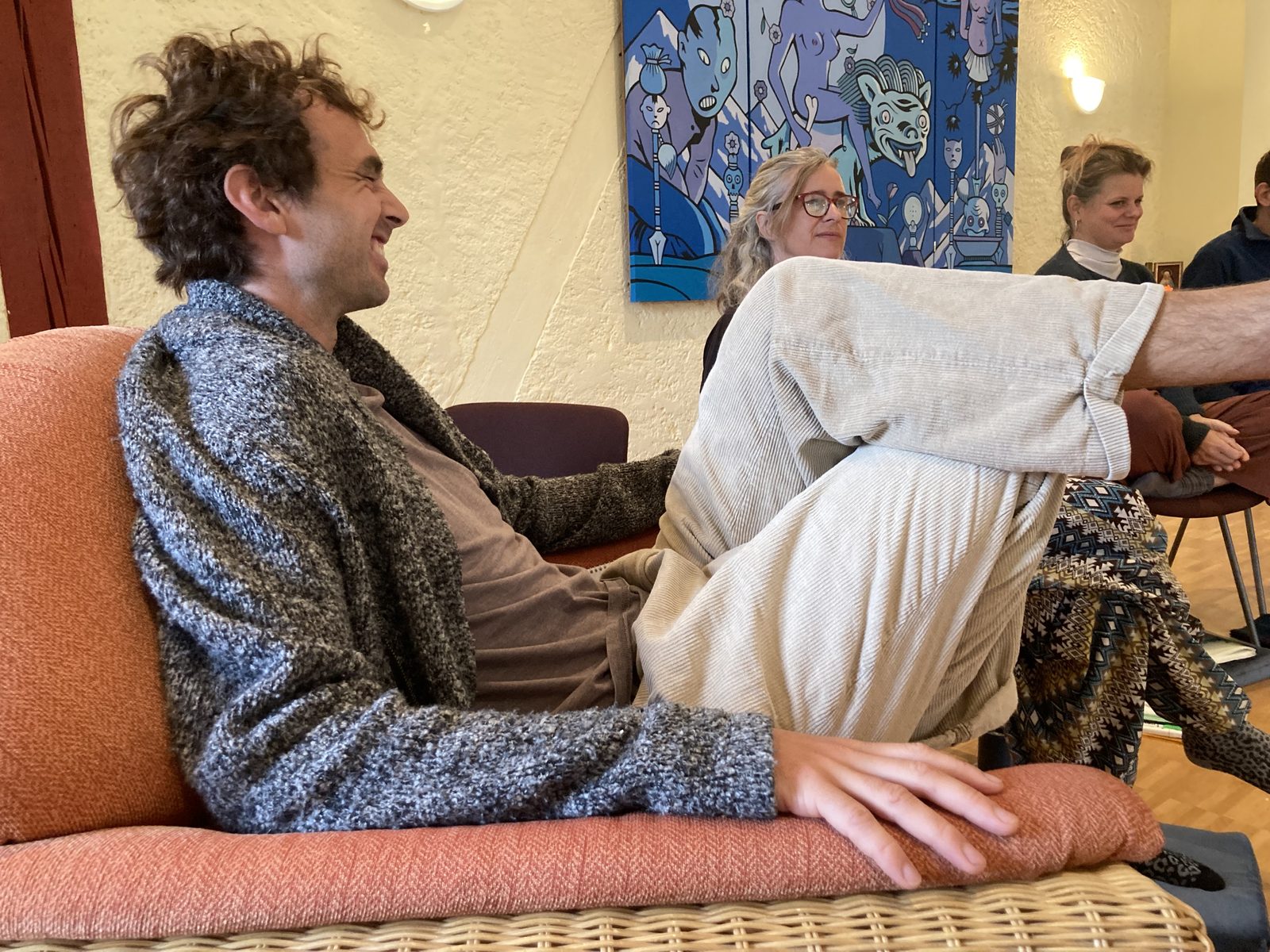 A participant laughing on the sofa between sessions