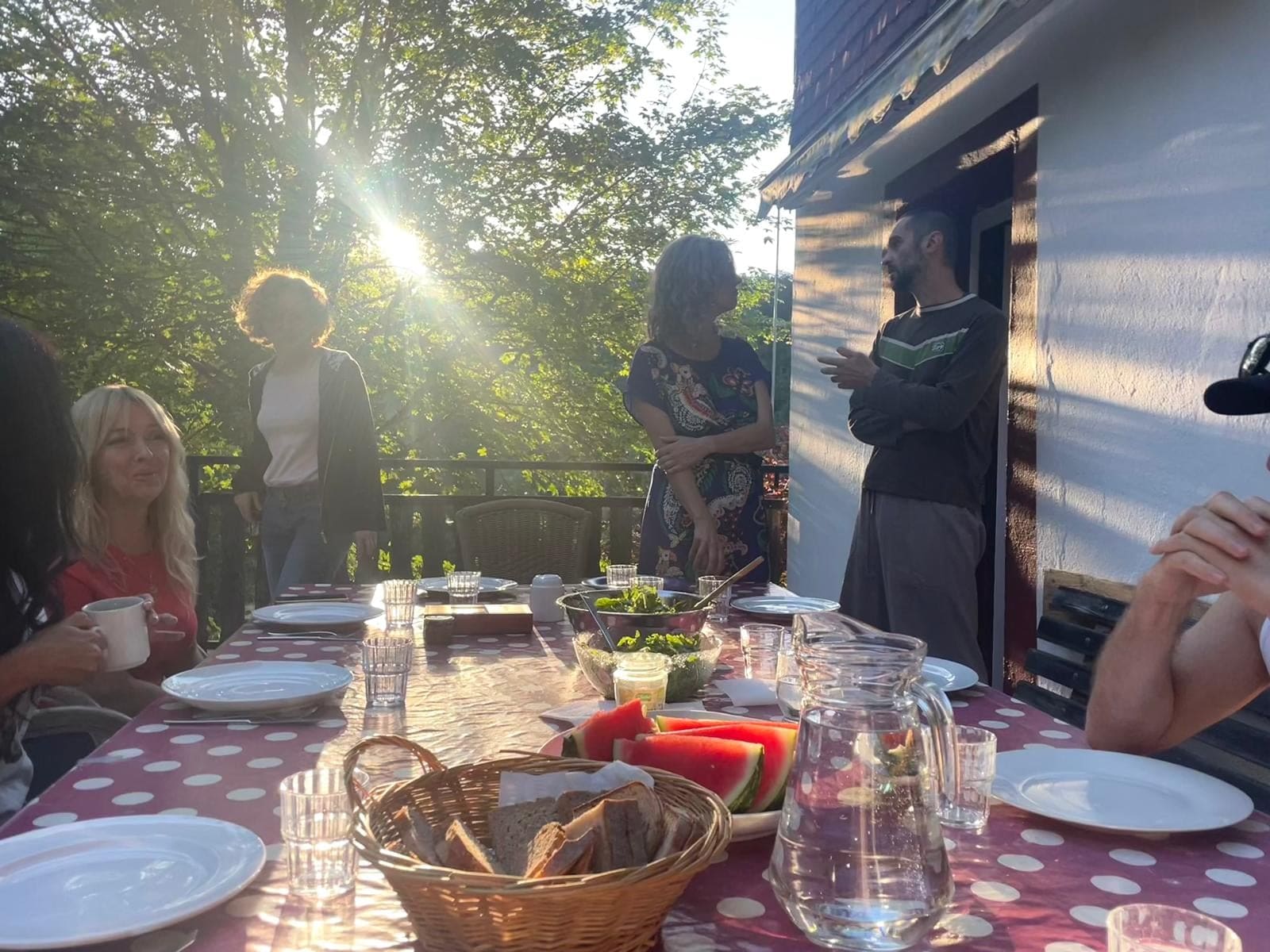 A participant speaking to the group on the terrace
