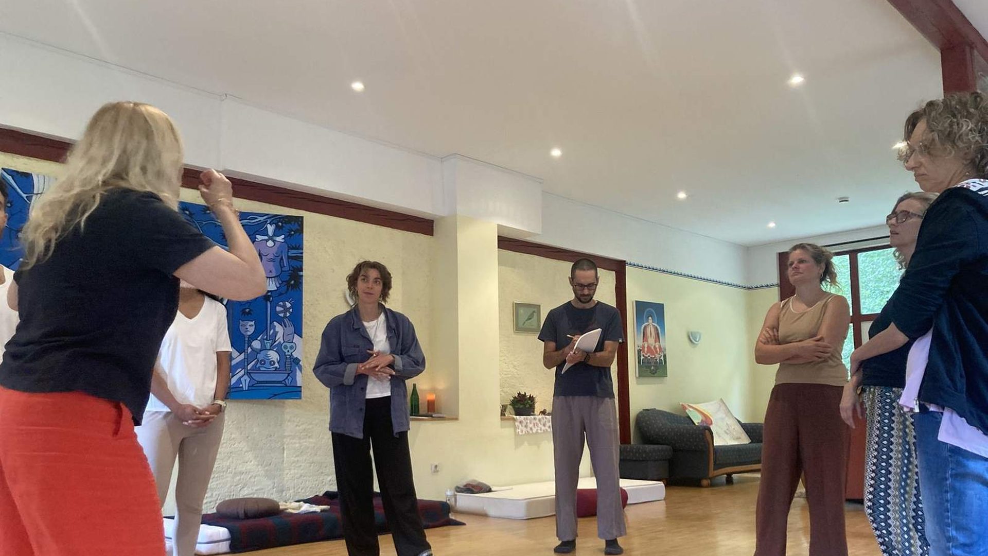 Participants standing together in a circle during an intensive