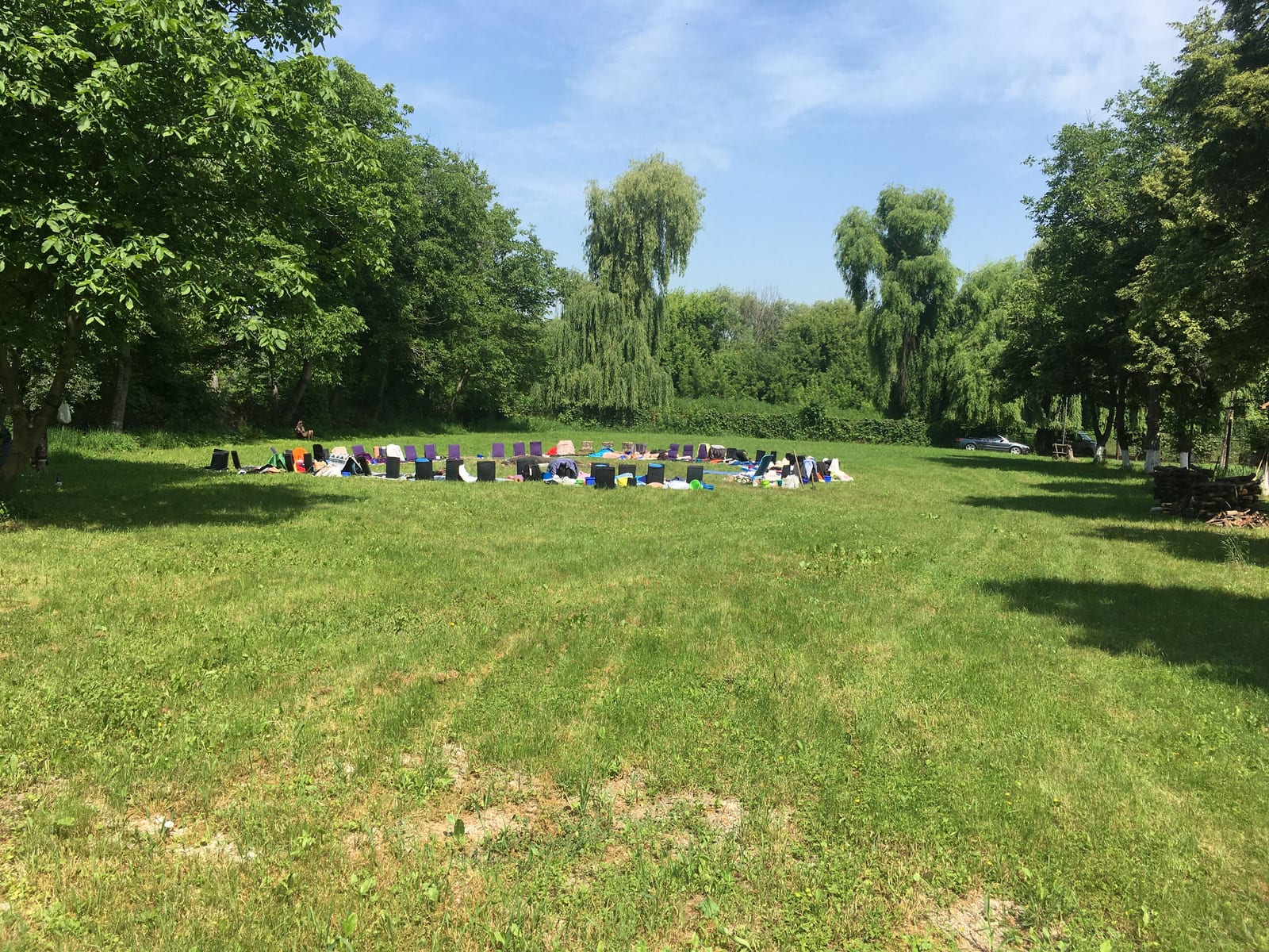 An outdoor seminar circle set up in a riverside meadow near the Dniester