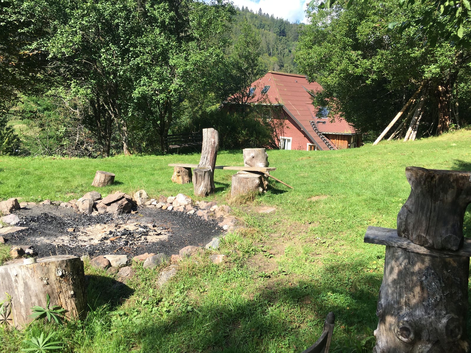 The garden fire circle with the seminar house beyond